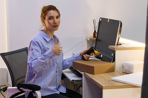 istock Woman giving approval sign with scanner in hand 2246007291