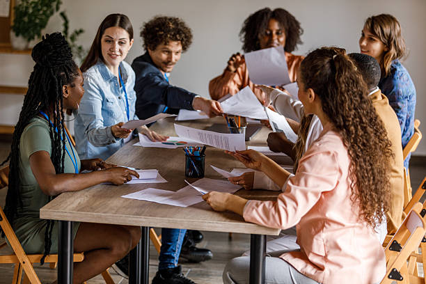 istock Business people exchanging documents during insightful meeting 2246008489