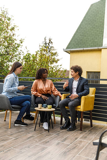 istock Colleagues having coffee on the balcony during office break 2246008620