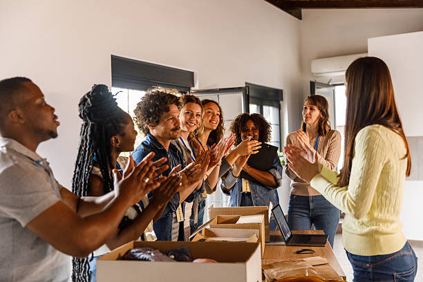 istock Group of volunteers applauding after successfully preparing donations 2246011015