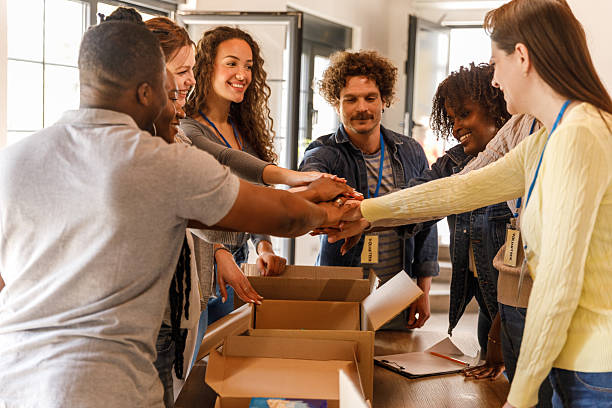 istock Group of volunteers putting their hands together in a stack 2246011016