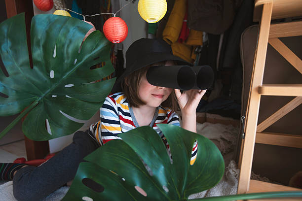 istock Child explores indoor jungle with handmade binoculars 2246013583