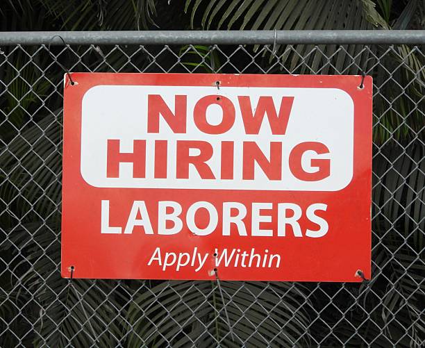 istock Now Hiring Laborers Apply Within - sign on a fence 2246014209