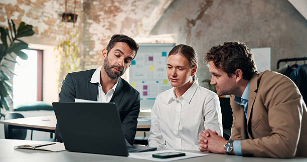 istock Reading, document and group with laptop, office or plan for investment proposal, project and talking. Business analyst, teamwork and people with tech for funding opportunity, review and paperwork 2246015600