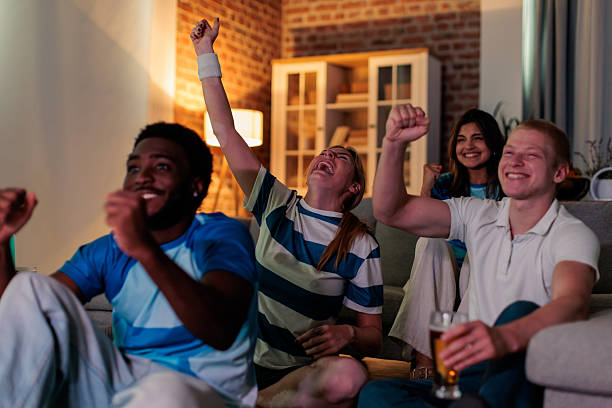 istock Friends Cheering for Their Favorite Team at Home 2246016230