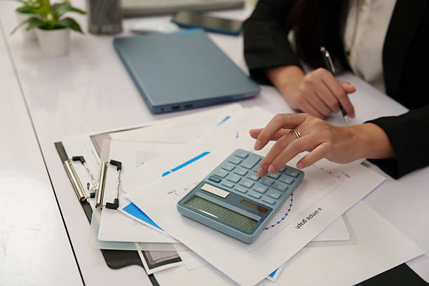 istock Focus on businesswoman's hands working on computer typing and pressing calculator. 2246016621