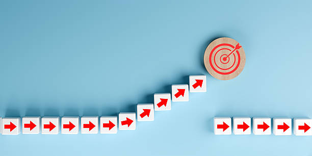 istock Business Target Achievement Concept with Arrows Reaching Bullseye on Blue Background 2246018697