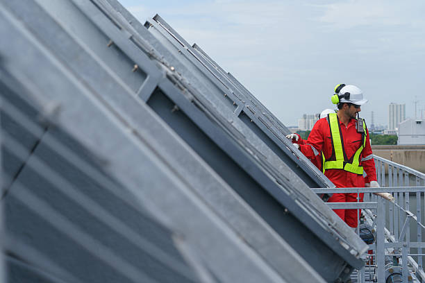 istock Two construction engineers inspect a cooling tower system in an industrial area. They focus on the complex process of dismantling the cooling system as part of a necessary maintenance job. 2246019228
