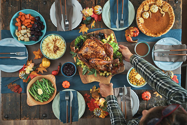 istock Having Stuffed Turkey for Thanksgiving Holiday Dinner with Vegetables and Gravy 2246020718