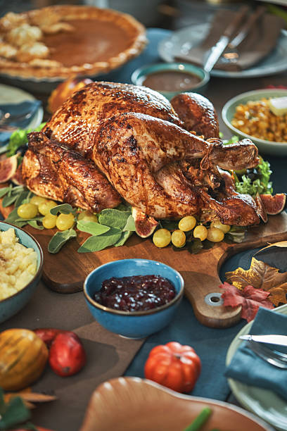 istock Having Stuffed Turkey for Thanksgiving Holiday Dinner with Vegetables and Gravy 2246020890