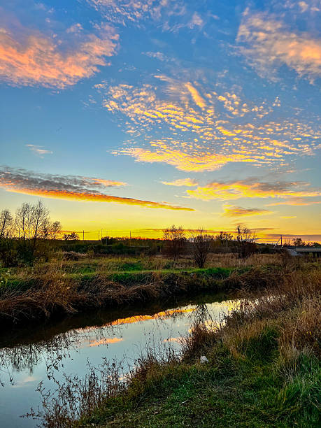 istock Golden hour clouds reflecting in tranquil river landscape 2246021065