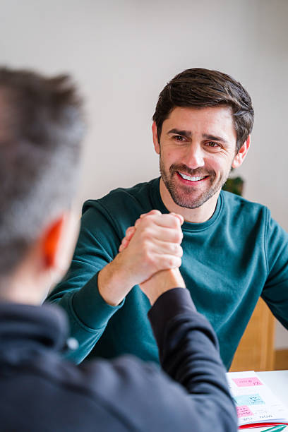 istock Two men arm wrestling smiling in friendly competition 2246028171