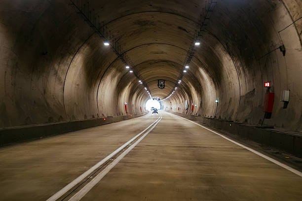 istock Road tunnel in mountain illuminated by lamps 2246028771
