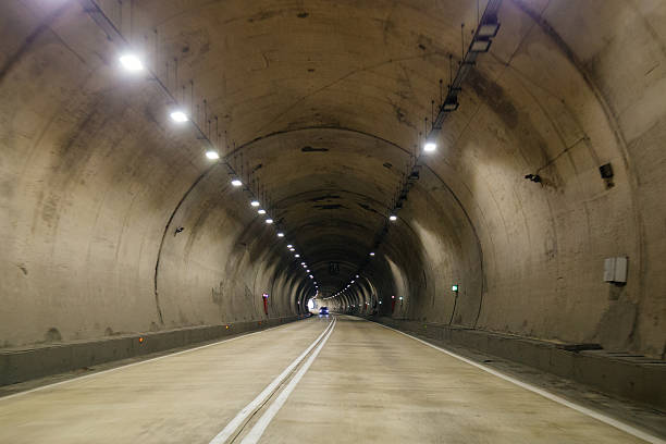istock Road tunnel in mountain illuminated by lamps 2246028778