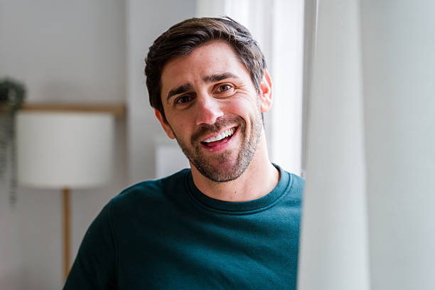 istock Happy young man smiling in a natural light portrait 2246029008