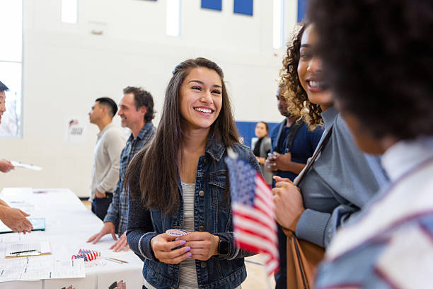 Diverse group of smiling people participating in a civic event indoors