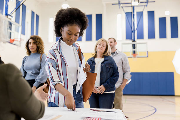 istock Diverse people in line, participating in a civic duty event indoors. 2246029190