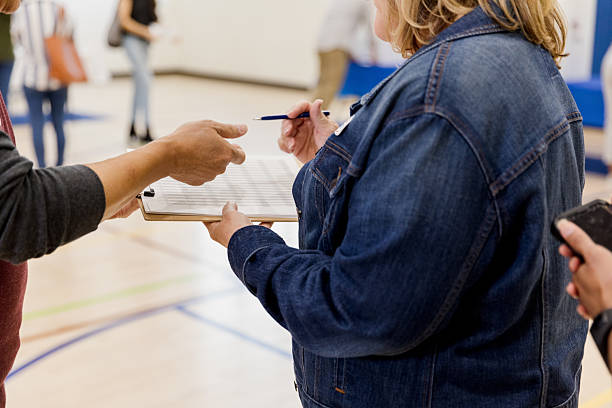 istock Adults reviewing document on clipboard during casual indoor activity 2246029229