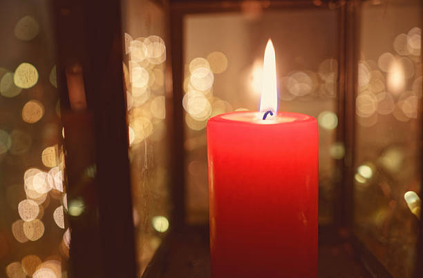 istock Close-Up of Lit Red Candle With Reflections on Lantern Glass 2246029773