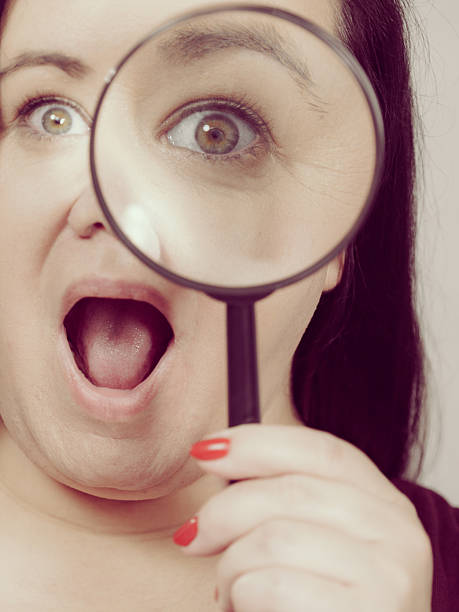 istock Adult woman with magnifying glss 2246030032