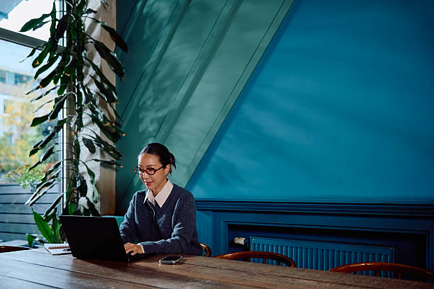 istock Woman working on laptop in modern creative office 2246033351