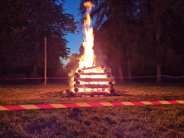 Large campfire burning at night in outdoor field
