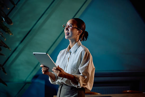istock Asian businesswoman using tablet presenting information in office 2246034736