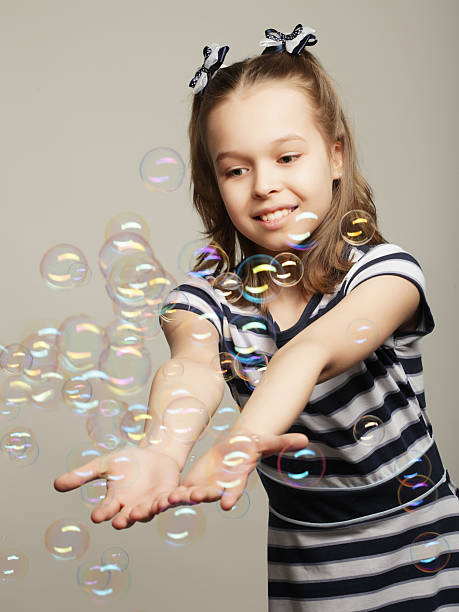 istock funny lovely little girl witj soap bubbles 2246036090