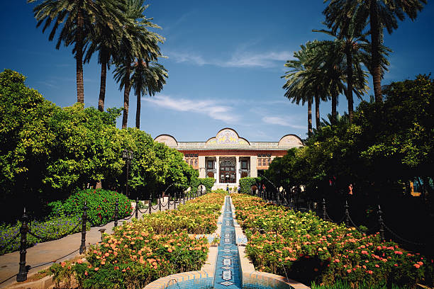 istock Scenic Garden with Grand Building and Palm Trees 2246037280
