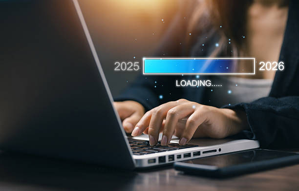 istock Hands typing on laptop with digital progress bar loading from 2025 to 2026. Concept of business growth, technology progress, and new year goal achievement in futuristic innovation. 2246038093