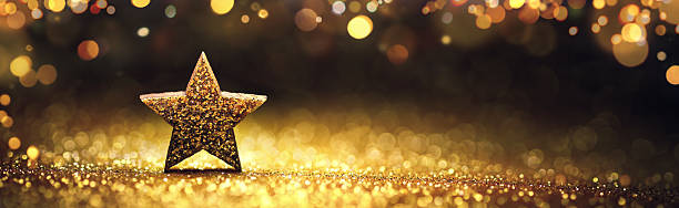 istock Christmas star on gold glittering background 2246040800