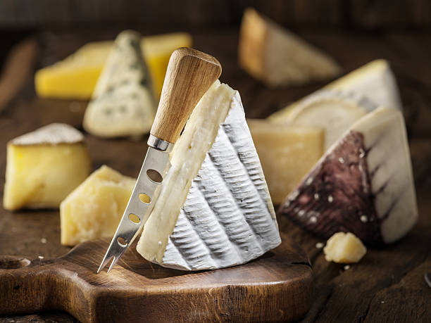istock Brie cheese and assorted cheese plate on rustic wooden board. Restaurant menu concept. 2246044729