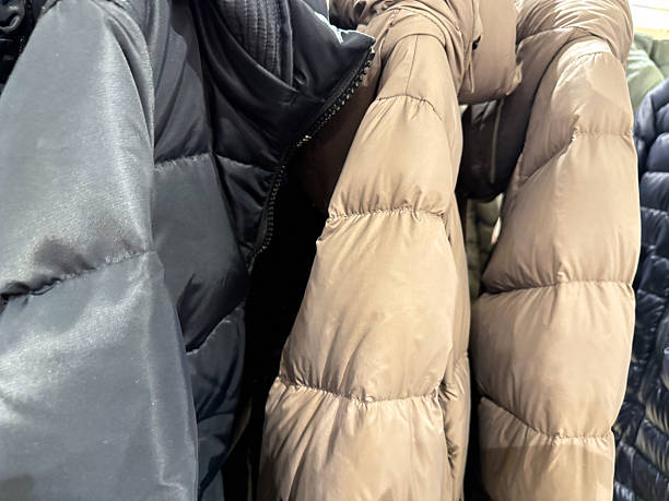 istock Row of hooded down jackets in store 2246046768