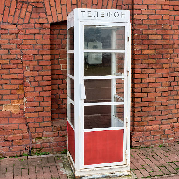 istock An old telephone booth against a brick wall. 2246050745