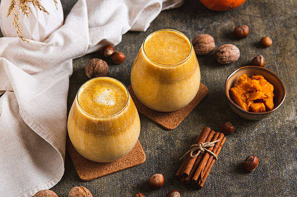 istock Autumn latte with pumpkin puree, nuts and cinnamon in glasses on the table 2246052309