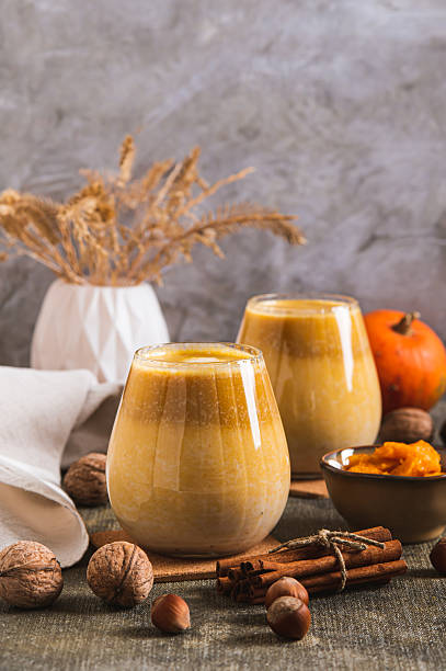 istock Warming pumpkin nut latte in glasses on the table vertical view 2246052310