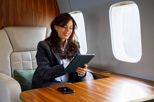 istock Woman travelling on a private airplane, working on a tablet computer. She is happy and productive during the executive trip 2246053114