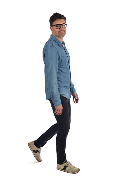istock smiling man walking and looking at camera on white background 2246055180