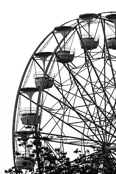 Minimalist Black and White Ferris Wheel Structure Against Bright Sky
