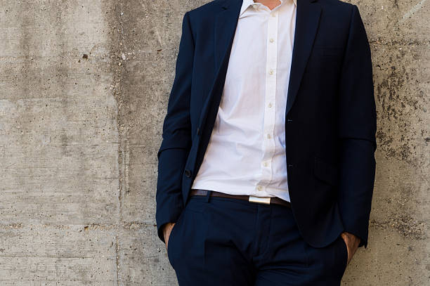 istock Confident Businessman Leaning Against Wall with Hands in Pockets 2246055353