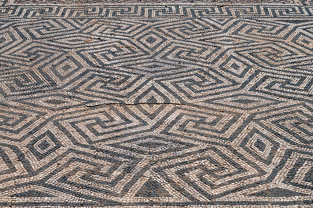 Mosaic flooring, ancient classical style, braid shape. Tiled flooring,old and weathered. Image suitable for backgrounds. Galicia, Spain.