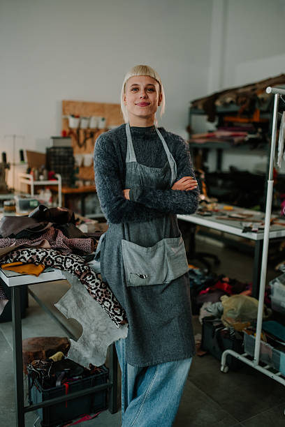istock Empowered woman artisan smiling in creative workshop 2246056236