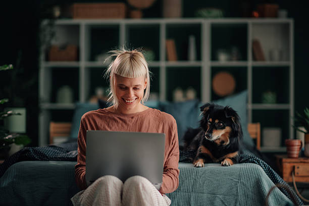 Woman working remotely with dog at home