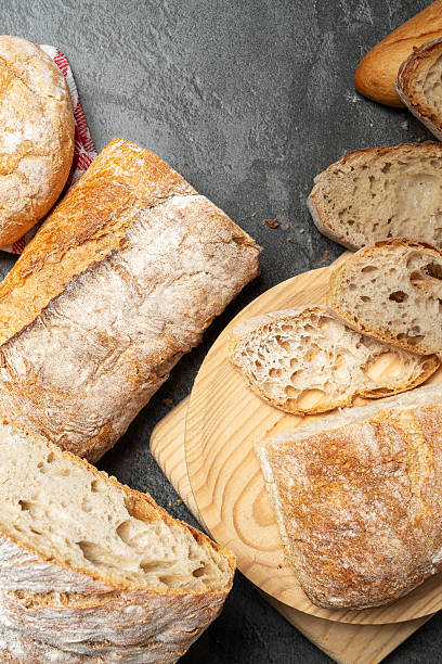 istock Artisan sourdough bread loaves sliced on cutting board 2246059406