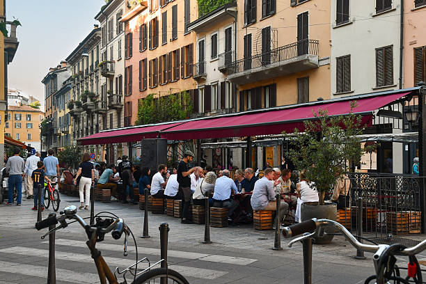 Milan, Lombardy, Italy - May 01 2025: A vibrant street scene in Corso Garibaldi, a well-known commercial street in the city centre, with people dining at an outdoor restaurant.