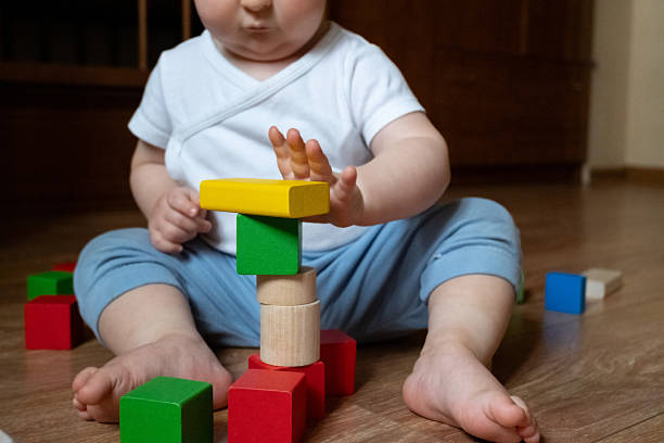 istock Child Playing with Eco-Friendly Wooden Blocks 2246061330