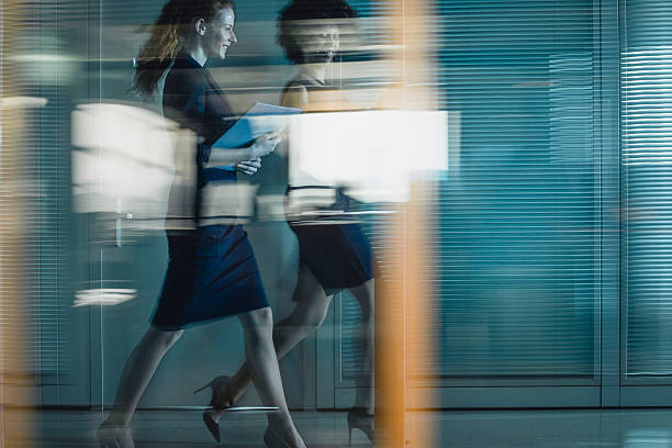istock Diverse Businesswomen Swiftly Walking Through Office Corridor with Determination 2246061851