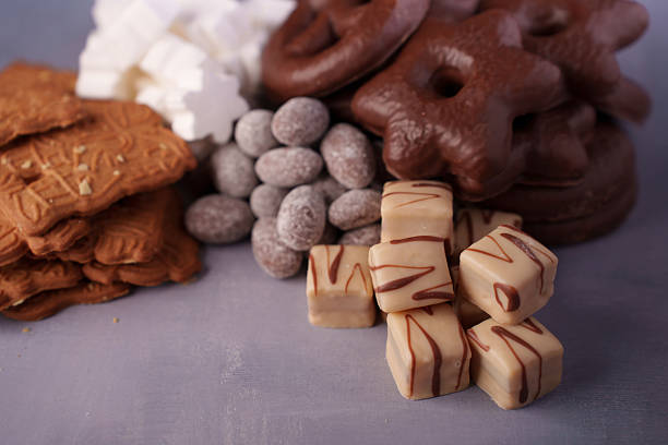 istock assorted festive treats with chocolate-covered delights and spice biscuits on subtle purple background: a cozy celebration of sweetness and savory seasonal flavors, smooth, crumbly, delicious 2246062485