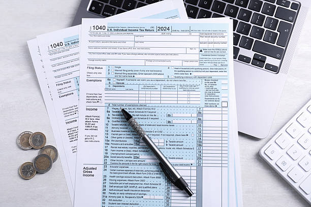 istock Tax forms, coins, pen, laptop and calculator on light grey table, flat lay 2246063463