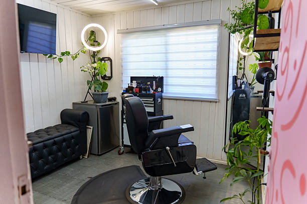 Modern barbershop showcasing a clean interior, barber chair, grooming tools, and lush green plants